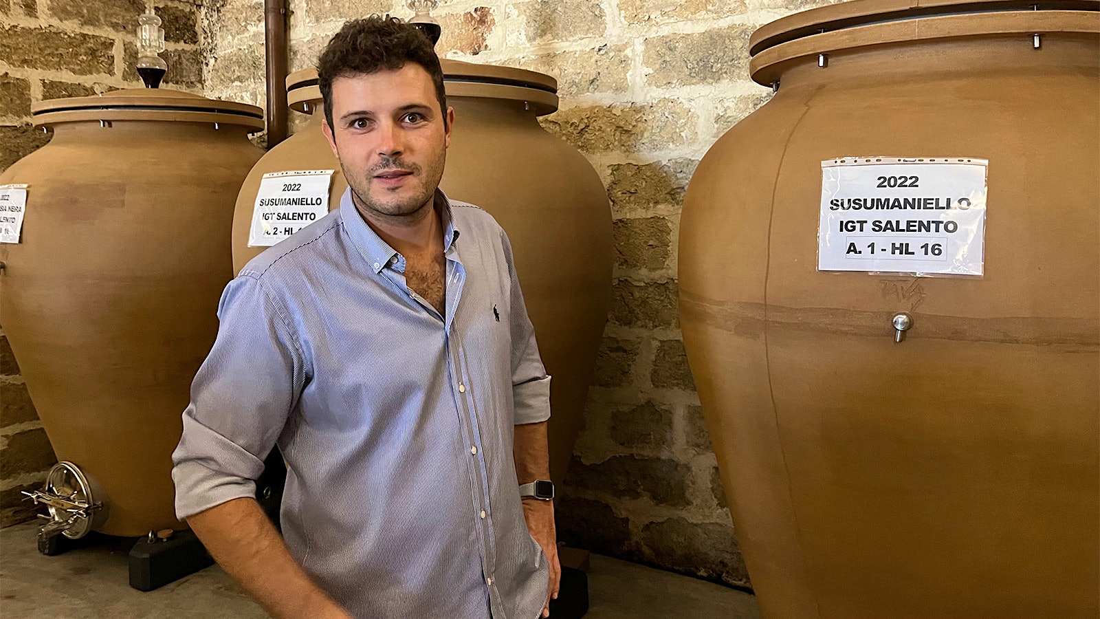 General manager Alessandro Falvo in front of clay amphorae in the winery of Masseria Li Veli